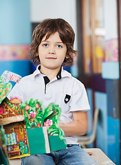 Image showing Boy With Popup Book Sitting On Desk In Classroom