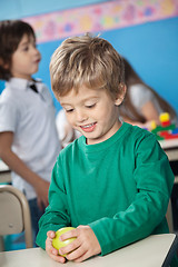 Image showing Boy Holding Smith Apple