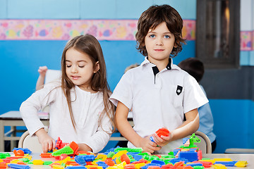 Image showing Boy With Female Friend Playing Blocks In Classroom