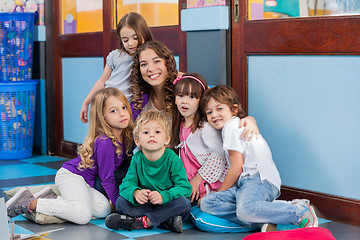 Image showing Teacher And Students Sitting Together On Floor