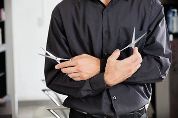 Image showing Male Hairstylist Holding Two Scissors