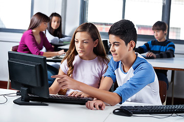 Image showing Teenage Friends Using Computer In Lab