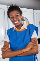 Image showing Female Helper Standing With Arms Crossed In Laundry