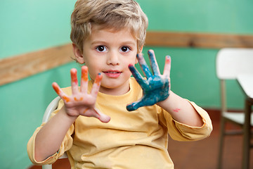 Image showing Boy Showing Colored Palms In Art Class