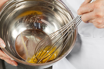 Image showing Female Chef Beating Eggs With Wisk