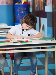 Image showing Boy With Color Pencils Drawing In Classroom