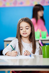 Image showing Girl Drawing With Sketch Pen In Preschool