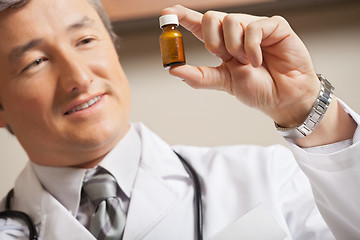 Image showing Doctor Looking At Medicine Bottle