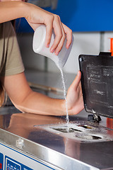 Image showing Woman Pouring Detergent Powder In Washing Machine