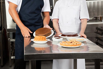 Image showing Chefs With Sweet Dishes At kitchen Counter