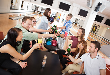 Image showing Friends Toasting Drinks in Bowling Club