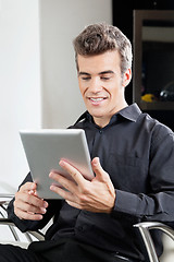 Image showing Male Client Using Digital Tablet In Salon