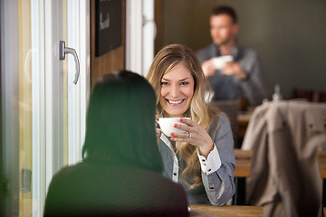 Image showing Young Woman With Friend Having Coffee At Cafe