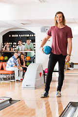 Image showing Young Man Holding Ball At Bowling Club