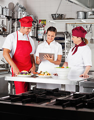 Image showing Chefs Using Digital Tablet In Kitchen