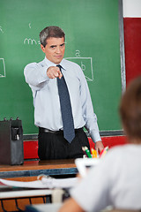 Image showing Male Teacher Pointing At Schoolboy