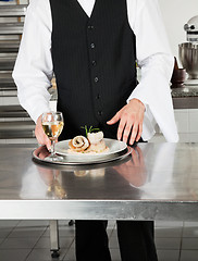 Image showing Waiter With Salmon Roll And White Wine