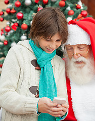 Image showing Boy Showing Smartphone To Santa Claus