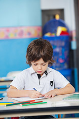 Image showing Boy With Sketch Pens Drawing In Kindergarten