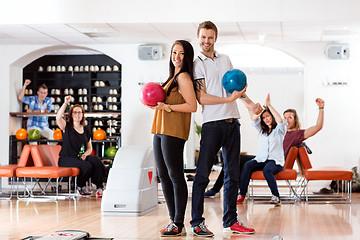 Image showing Young Man And Woman With Bowling Balls in Club