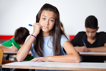 Image showing Teenage Schoolgirl Sitting At Desk