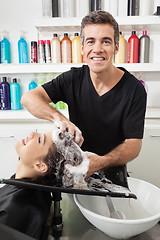 Image showing Hairstylist Washing Customer's Hair At Salon