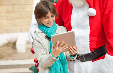 Image showing Santa Claus And Boy Using Digital Tablet