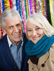 Image showing Happy Couple Against Tinsels At Christmas Store