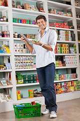 Image showing Man Checking List On Digital Tablet In Store