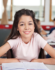 Image showing Schoolgirl Sitting At Desk In Classroom