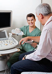 Image showing Technician Putting Gel On Patient's Hand