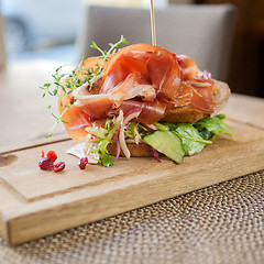 Image showing Parma Ham Sandwich On Wooden Plate