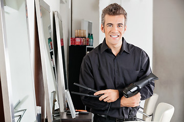 Image showing Male Hairstylist With Hairdryer And Straightener