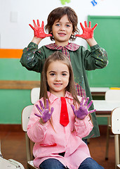 Image showing Boy And Girl Showing Colored Hands In Classroom