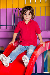 Image showing Little Boy Playing On Slide In Kindergarten