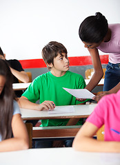 Image showing Boy And Teacher Looking At Each Other In Classroom