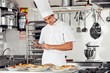 Image showing Male Chef Using Digital Tablet In Kitchen