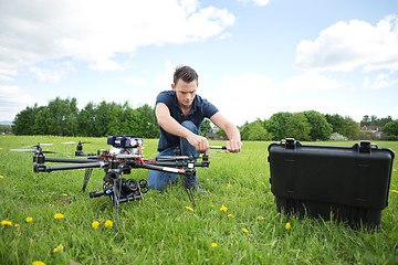 Image showing Technician Fixing Propeller Of UAV Helicopter