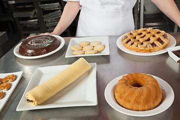 Image showing Female Chef With Variety Of Sweet Dishes