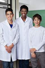 Image showing Teacher With Male Students Standing Together In Science Lab