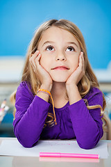 Image showing Girl Looking Up While Sitting With Head In Hands In Class