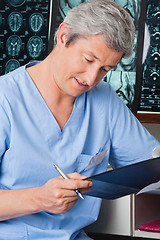 Image showing Medical Professional Going Through Document