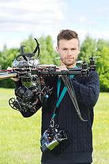 Image showing Male Engineer Holding UAV Helicopter in Park