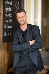 Image showing Businessman Standing Arms Crossed In Coffeeshop