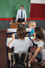 Image showing Students Using Digital Tablet At Desk