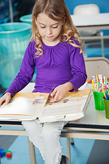 Image showing Girl Reading Book In Classroom