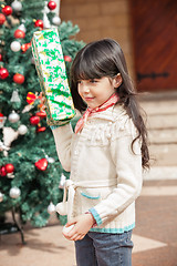 Image showing Girl Holding Present In Courtyard