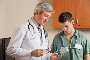 Image showing Medical Professionals Looking At Medicine Box