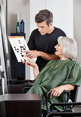 Image showing Hairdresser Advising Female Client In Selecting Color