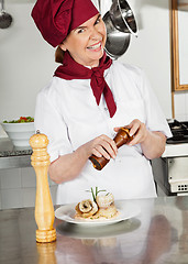 Image showing Female Chef Seasoning Dish With Peppermill